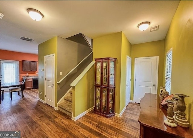 stairs with hardwood / wood-style floors