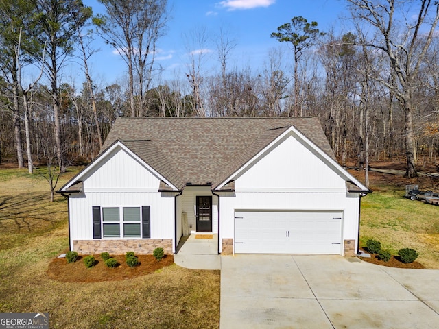 view of front of property with a garage and a front lawn