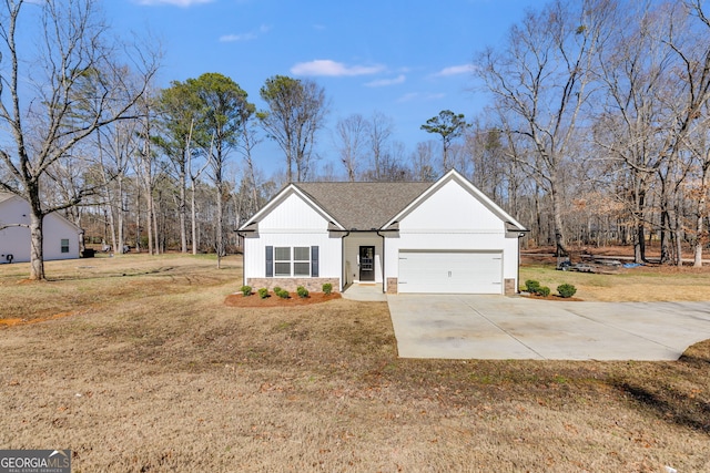 view of front of house featuring a garage and a front lawn