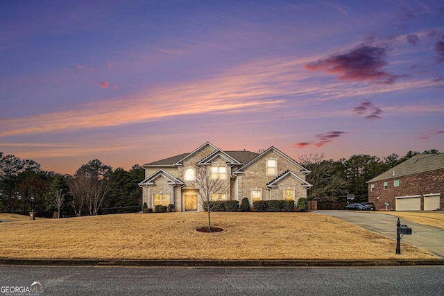 view of front of house with a garage and a lawn