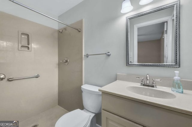 bathroom with toilet, walk in shower, and vanity