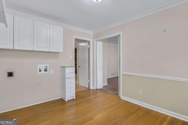 washroom featuring washer hookup, light wood-style floors, cabinet space, electric dryer hookup, and crown molding