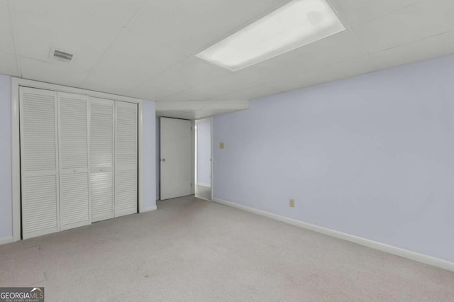 unfurnished bedroom featuring a closet, carpet, and baseboards