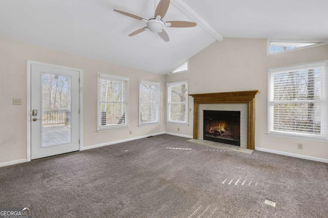 unfurnished living room featuring baseboards, a ceiling fan, lofted ceiling with beams, a fireplace with flush hearth, and carpet flooring