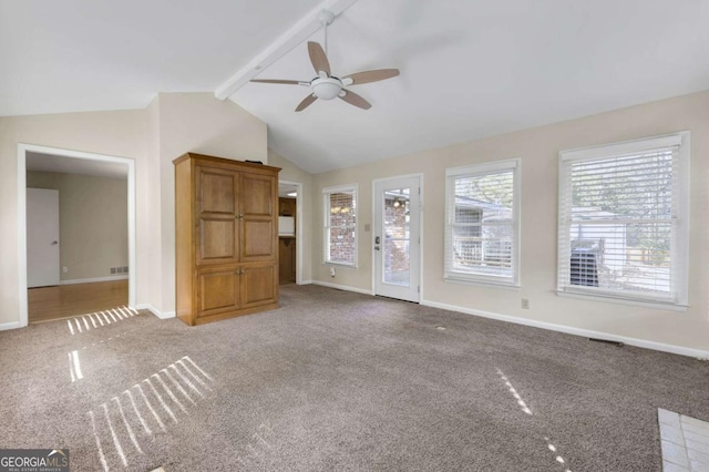 unfurnished living room with visible vents, baseboards, a ceiling fan, lofted ceiling with beams, and carpet flooring