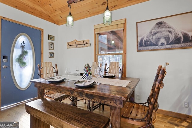 dining room with wood ceiling, lofted ceiling, wood-type flooring, and baseboards