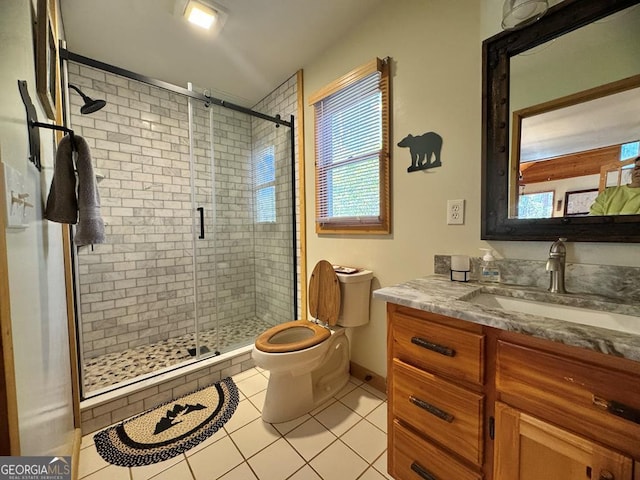 bathroom featuring toilet, a shower stall, vanity, and tile patterned floors