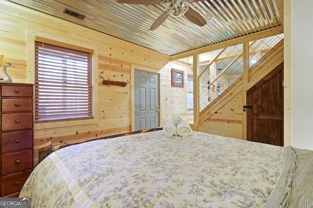 bedroom featuring wooden ceiling and wooden walls