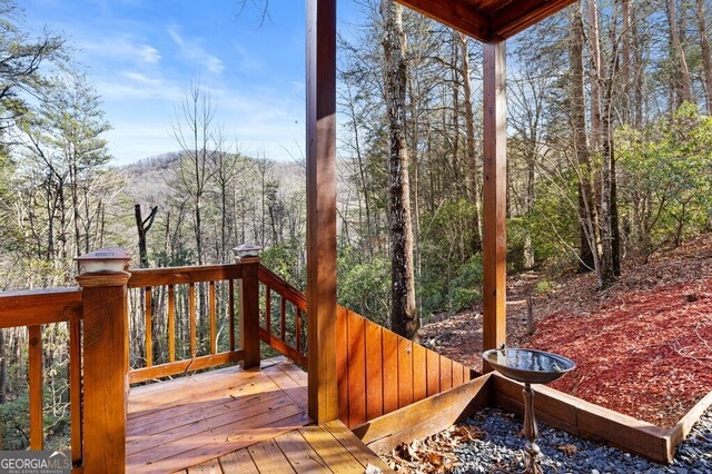 wooden deck featuring a wooded view