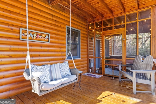 sunroom / solarium featuring wood ceiling and beam ceiling