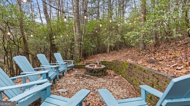 view of yard featuring an outdoor fire pit