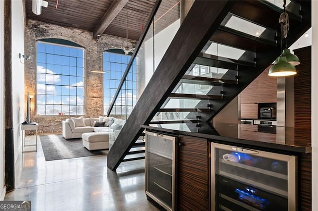 bar featuring wooden ceiling, a towering ceiling, beverage cooler, and beam ceiling