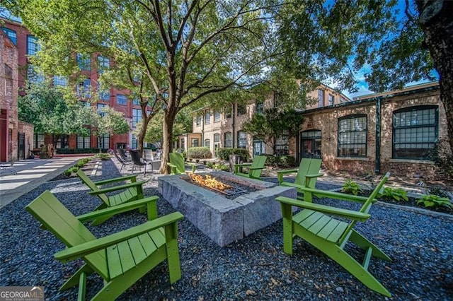 view of community with a patio area and a fire pit