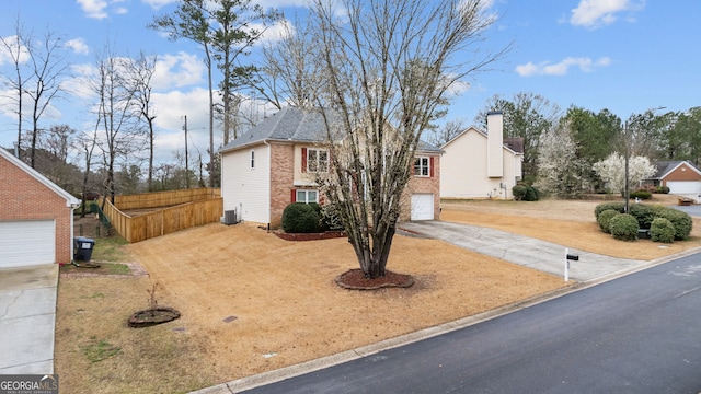 view of front of property with brick siding, driveway, fence, and central AC unit