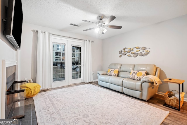 3655 Habersham Rd Unit B129, Atlanta, GA 30305 - living room with hardwood / wood-style flooring, ceiling fan, and a textured ceiling