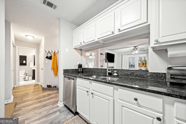 3655 Habersham Rd Unit B129, Atlanta, GA 30305 - kitchen featuring sink, white cabinetry, a textured ceiling, stainless steel dishwasher, and dark stone counters