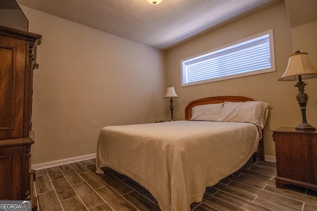 250 Little St Apt A105, Athens, GA 30605 - bedroom featuring wood tiled floors, baseboards, and a textured ceiling