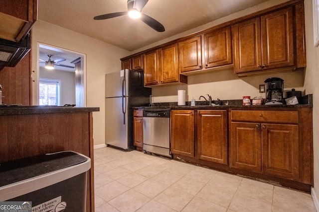 250 Little St Apt A105, Athens, GA 30605 - kitchen featuring appliances with stainless steel finishes, ceiling fan, brown cabinets, a sink, and light tile patterned flooring