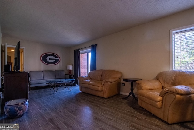 250 Little St Apt A105, Athens, GA 30605 - living room with dark wood-style flooring, a textured ceiling, and baseboards