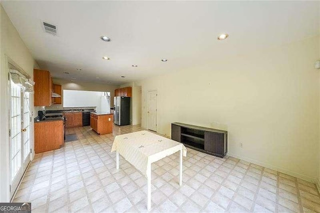 kitchen featuring stainless steel fridge and a center island