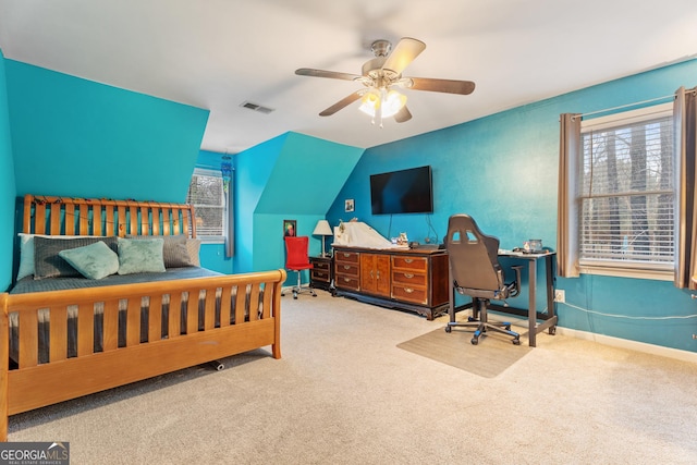 bedroom featuring multiple windows, vaulted ceiling, and carpet flooring