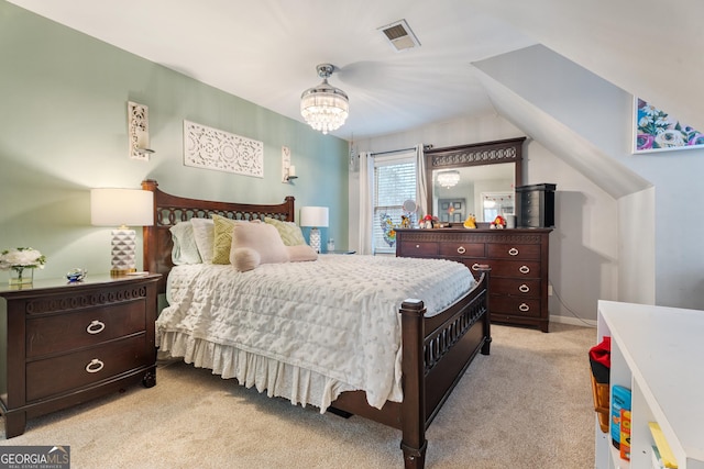 carpeted bedroom with a notable chandelier