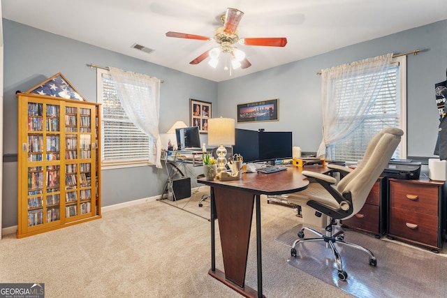 office space featuring light colored carpet and ceiling fan