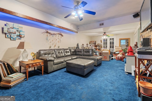 carpeted living room with ceiling fan