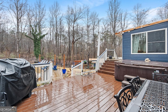 wooden deck featuring grilling area and a hot tub