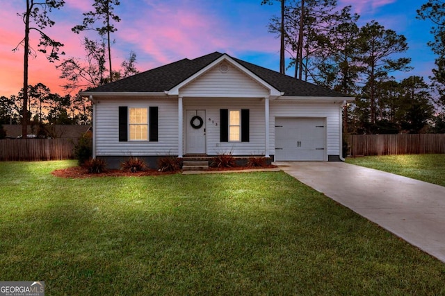 ranch-style house featuring a garage and a lawn