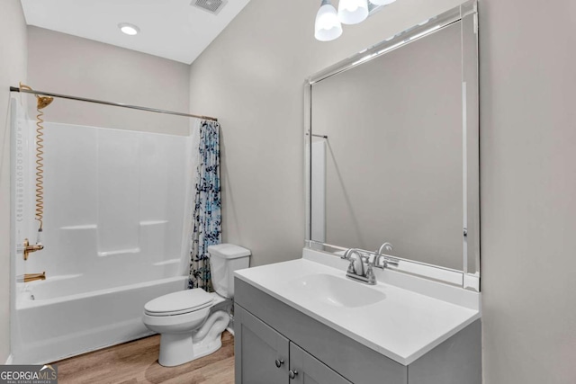 full bathroom with shower / tub combo, vanity, toilet, and hardwood / wood-style floors