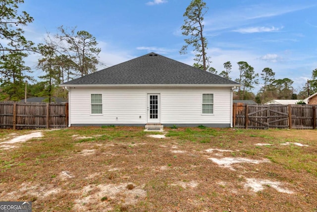 back of property featuring a lawn