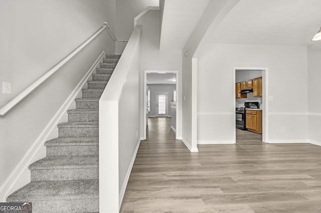 staircase with hardwood / wood-style flooring