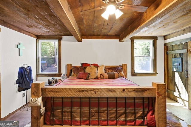 carpeted bedroom featuring beamed ceiling, wood ceiling, and multiple windows