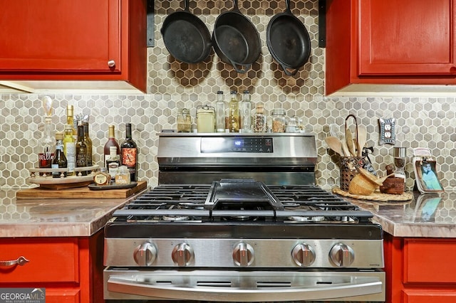 kitchen with stainless steel range with gas stovetop and decorative backsplash