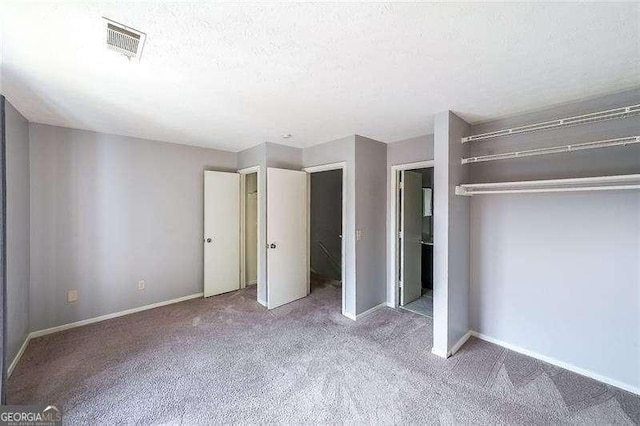 unfurnished bedroom with carpet flooring and a textured ceiling