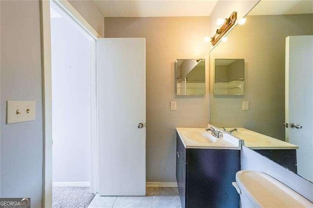 bathroom with vanity, tile patterned floors, and toilet