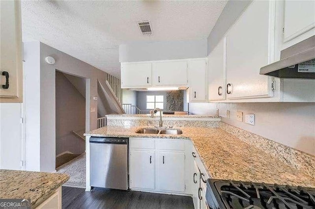 kitchen with light stone counters, sink, stainless steel dishwasher, and white cabinets