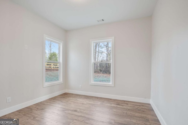 unfurnished room with a wealth of natural light and light wood-type flooring