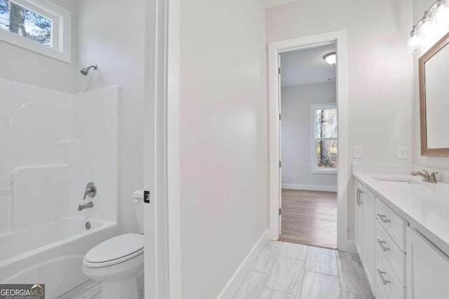 full bathroom featuring vanity, bathtub / shower combination, and toilet