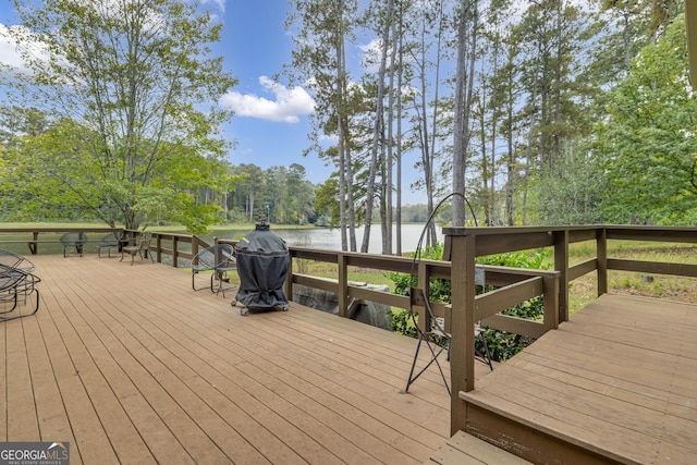 wooden terrace featuring a water view