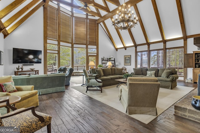 living area featuring high vaulted ceiling, plenty of natural light, and wood finished floors