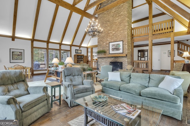 living room with wood finished floors, beamed ceiling, a fireplace, high vaulted ceiling, and a notable chandelier