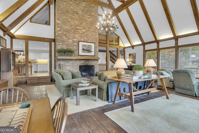 living room with high vaulted ceiling, dark wood-style flooring, a fireplace, beam ceiling, and an inviting chandelier