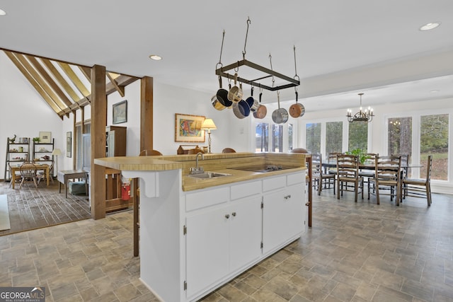 2724 Barnesville Hwy, Thomaston, GA 30286 - kitchen featuring stone tile floors, recessed lighting, white cabinets, a chandelier, and light countertops