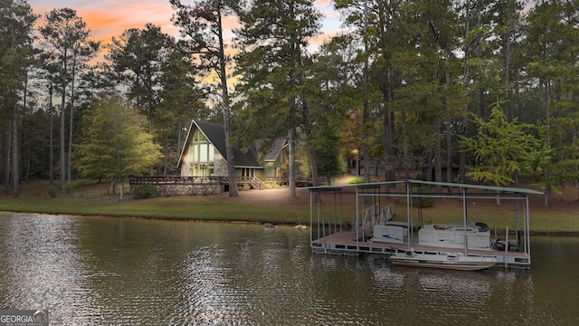 dock area featuring a lawn and a water view