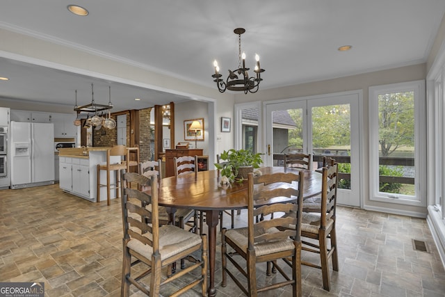 dining space featuring visible vents, stone finish floor, crown molding, a notable chandelier, and recessed lighting