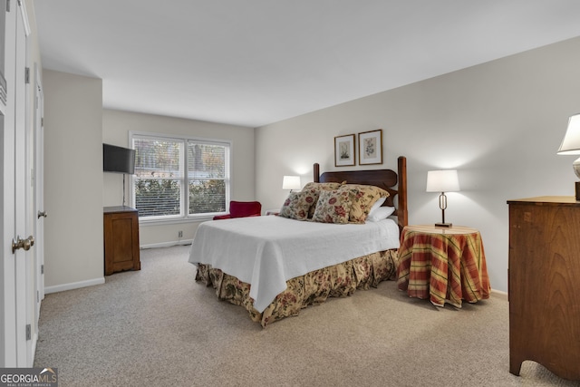 carpeted bedroom with baseboards