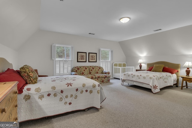 bedroom featuring carpet floors, multiple windows, and visible vents