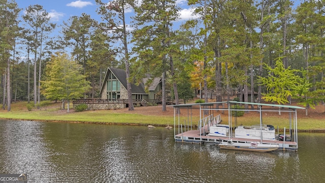 view of dock with a water view, a lawn, and boat lift